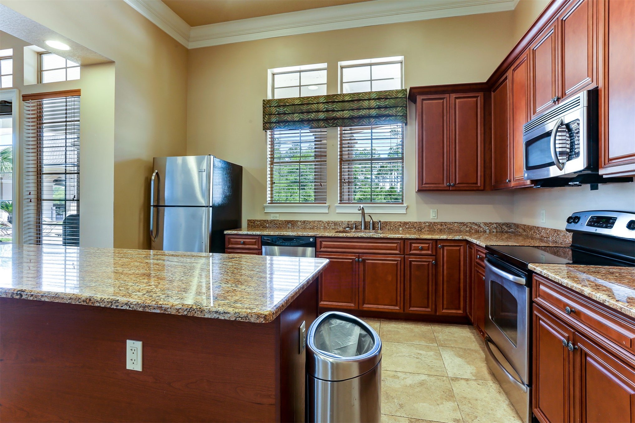 65860 Edgewater Drive Yulee, FL 32097 - Photo 31 of 39 a kitchen with kitchen island granite countertop a sink stove and cabinets