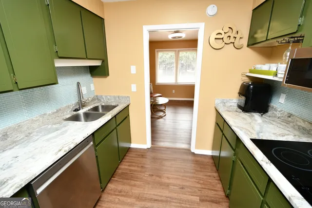 a kitchen with a sink and a stove top oven