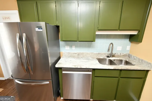 a kitchen with a refrigerator and a sink