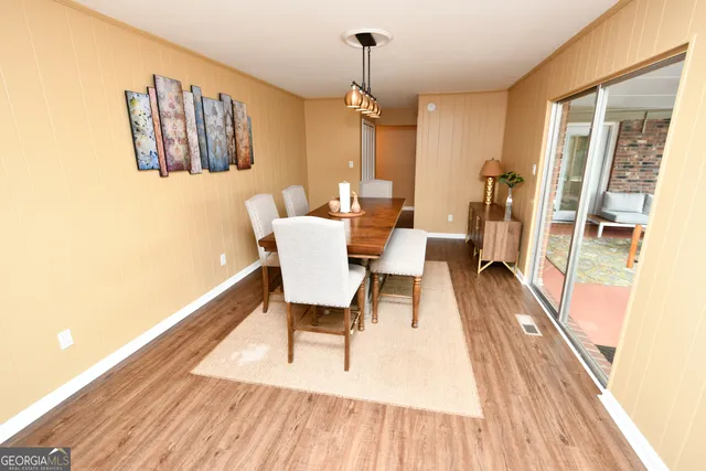 a view of a dining room with furniture window and wooden floor