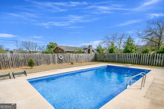 a view of a swimming pool with a lounge chairs