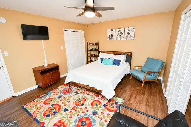 a bedroom with a bed and wooden floor