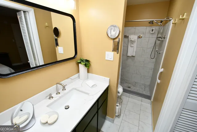 a bathroom with a sink vanity and mirror