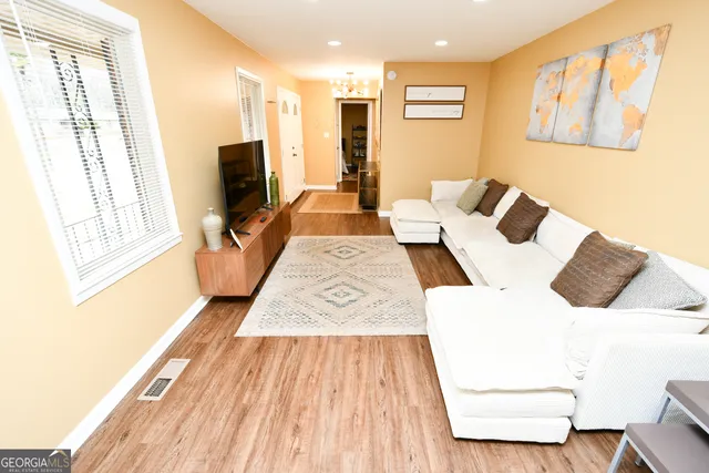 a living room with furniture and a flat screen tv
