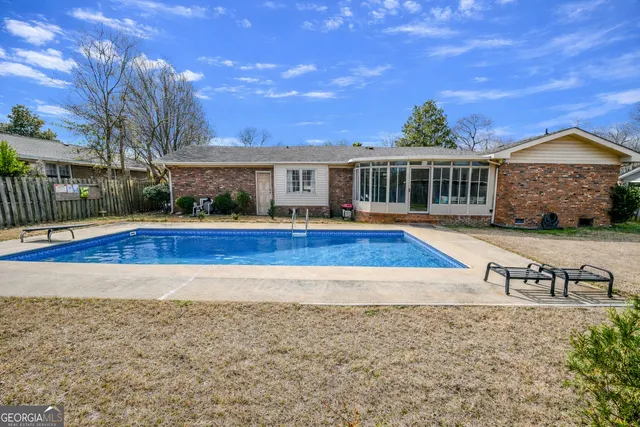 a view of house with yard and ocean view