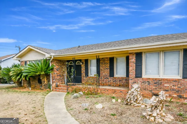 a view of a house with potted plants
