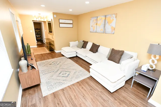 a living room with furniture and wooden floor