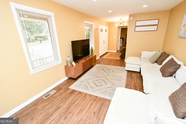 a living room with furniture and a flat screen tv