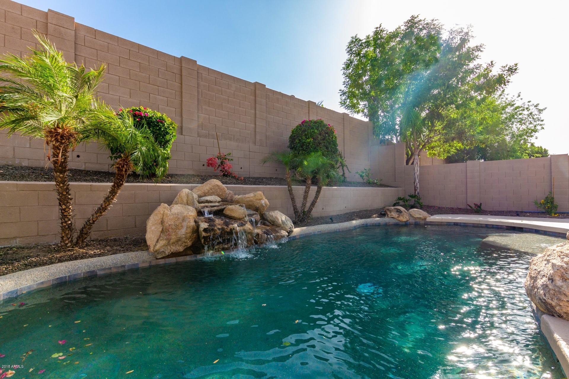 2033 West Caleb Road Phoenix, AZ 85085 - Photo 39 of 45 Rock waterfall and palm trees