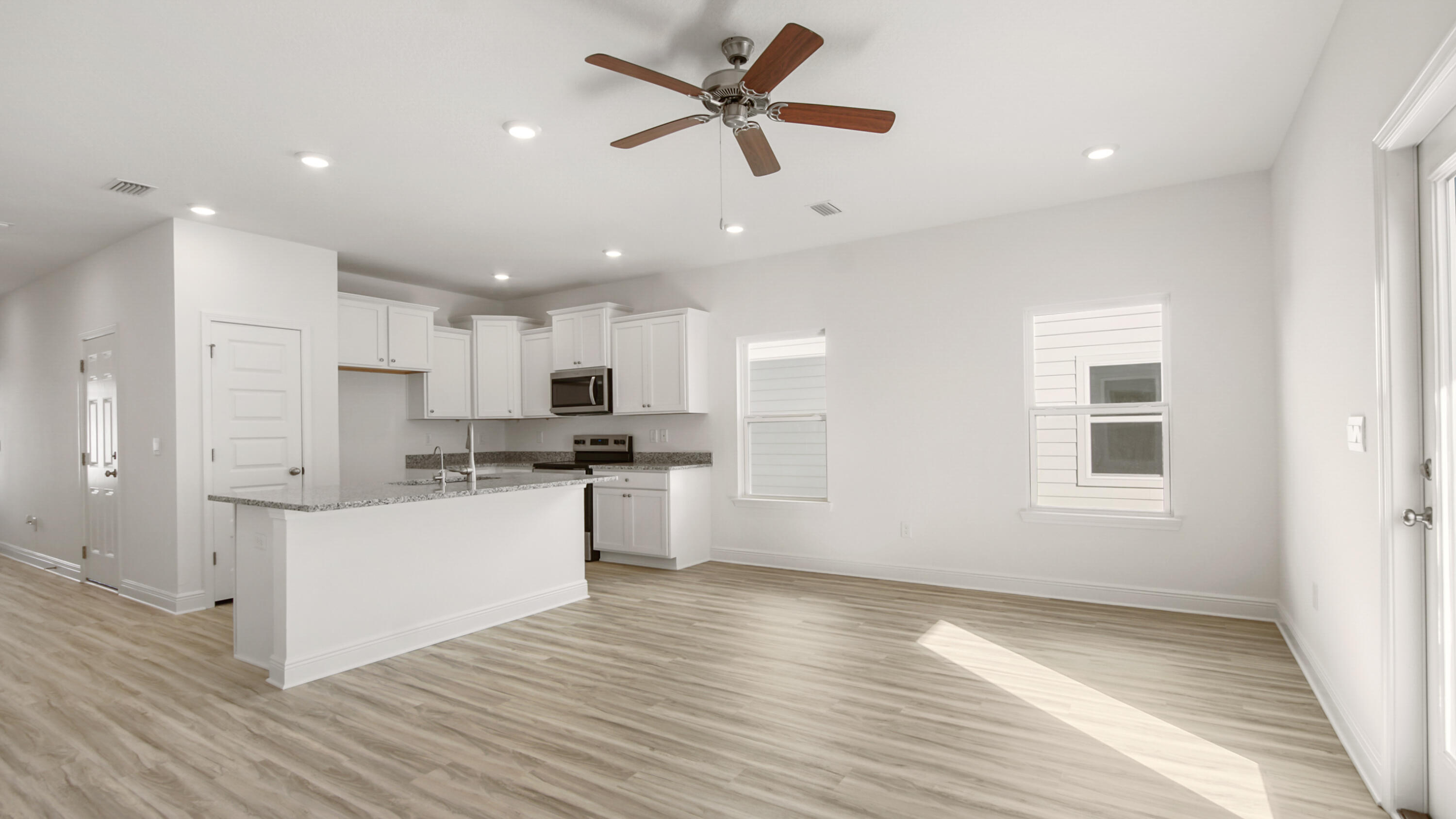 44 Phoenix Street Santa Rosa Beach, FL 32459 - Photo 13 of 37 a kitchen with a refrigerator and white cabinets