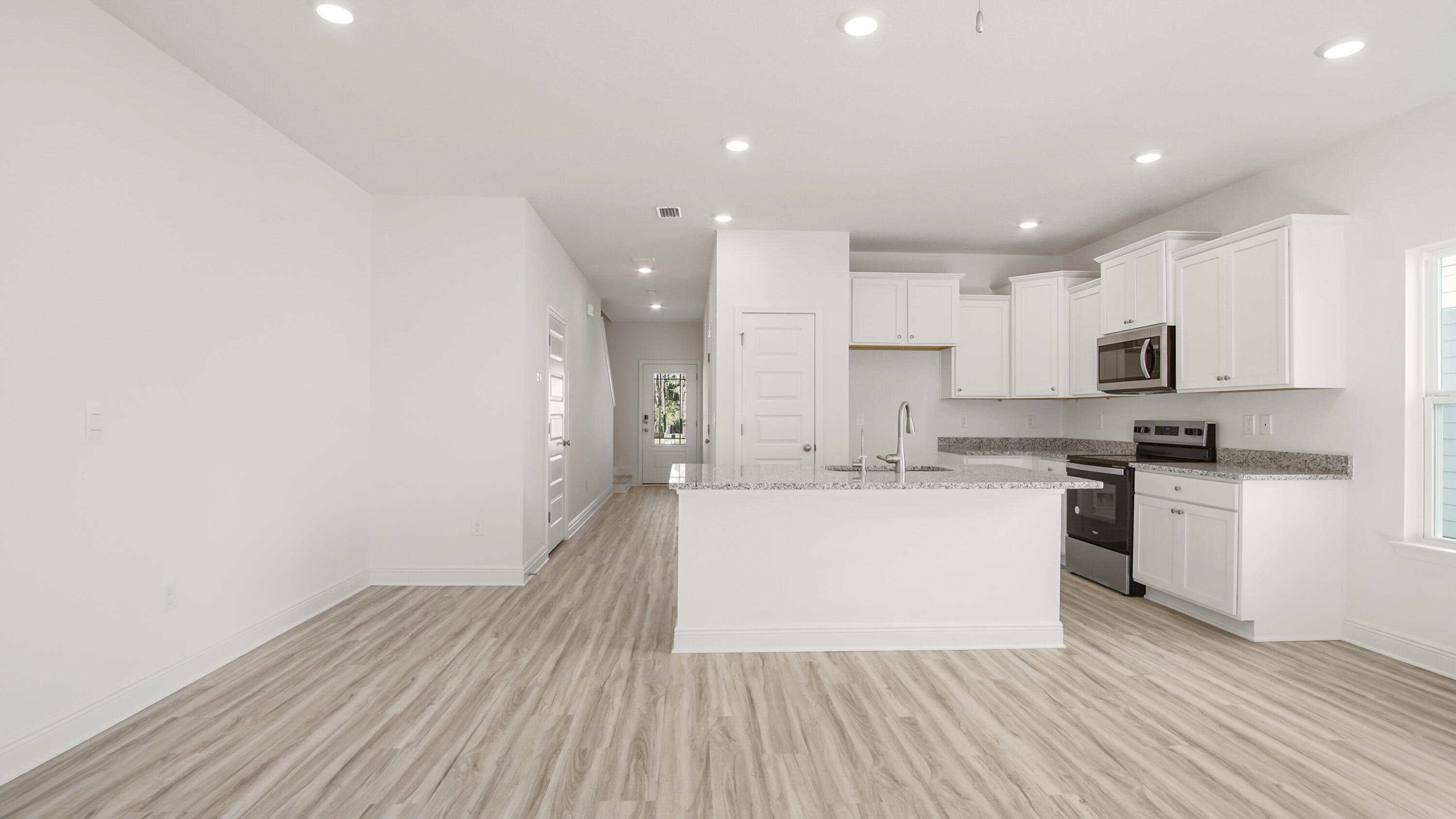 44 Phoenix Street Santa Rosa Beach, FL 32459 - Photo 14 of 37 a large kitchen with stainless steel appliances granite countertop a stove a sink and white cabinets with wooden floor