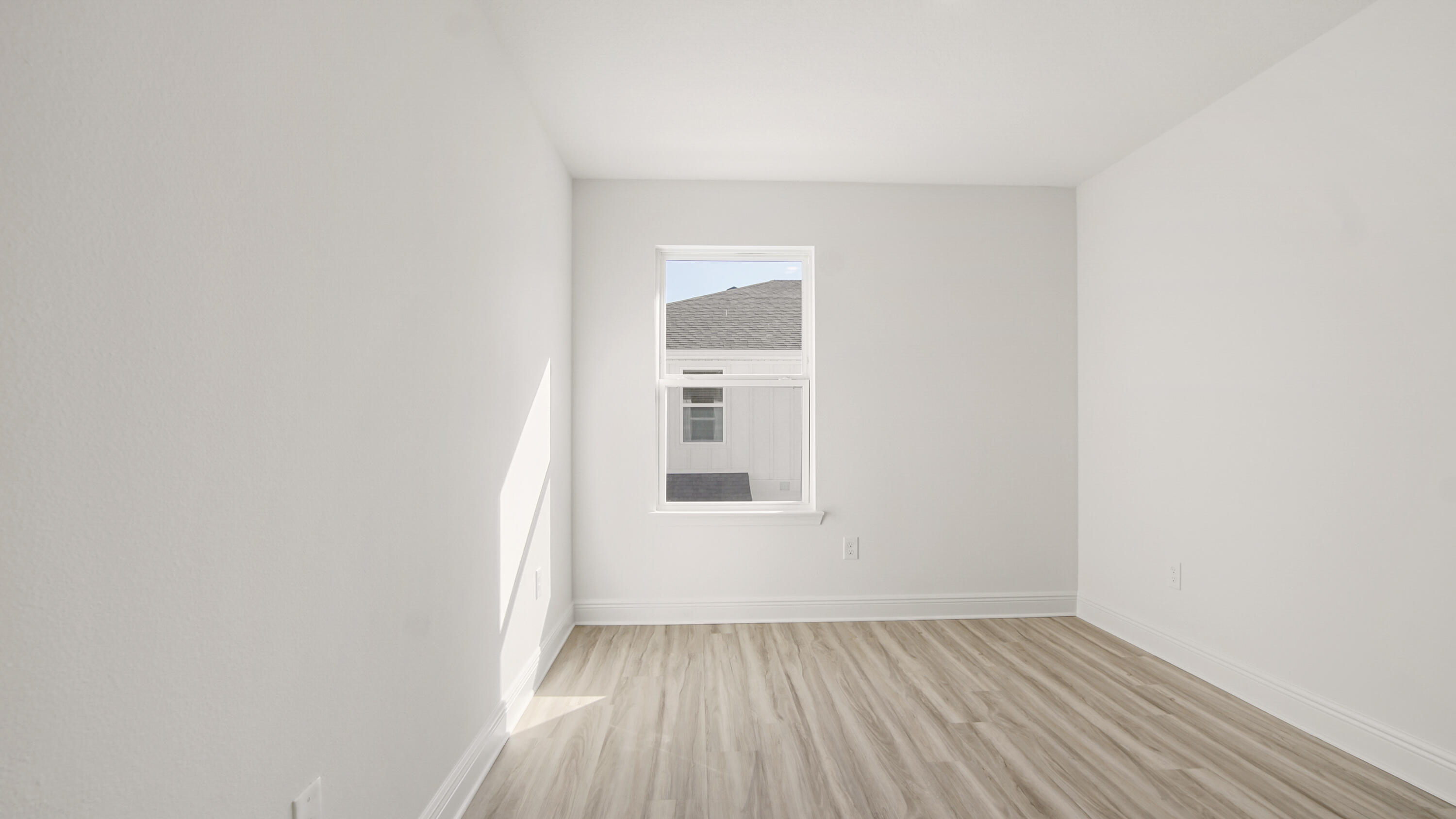 44 Phoenix Street Santa Rosa Beach, FL 32459 - Photo 30 of 37 a view of an empty room with wooden floor and a window