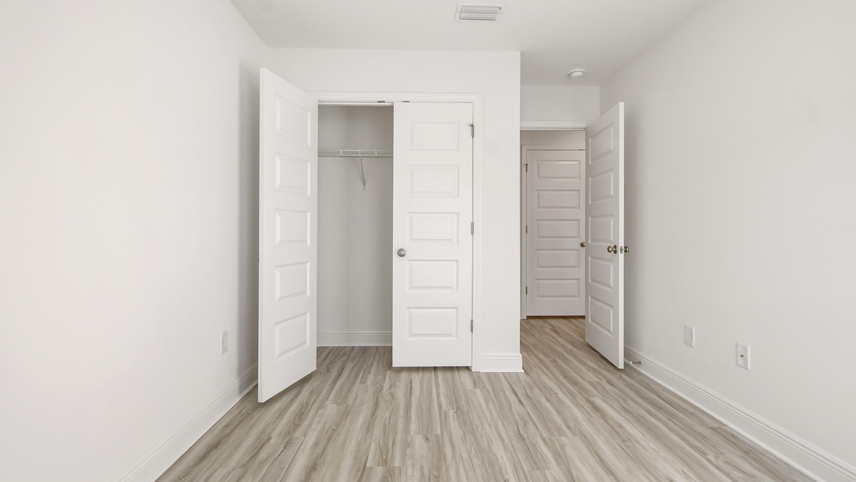44 Phoenix Street Santa Rosa Beach, FL 32459 - Photo 31 of 37 an empty room with wooden floor and closet