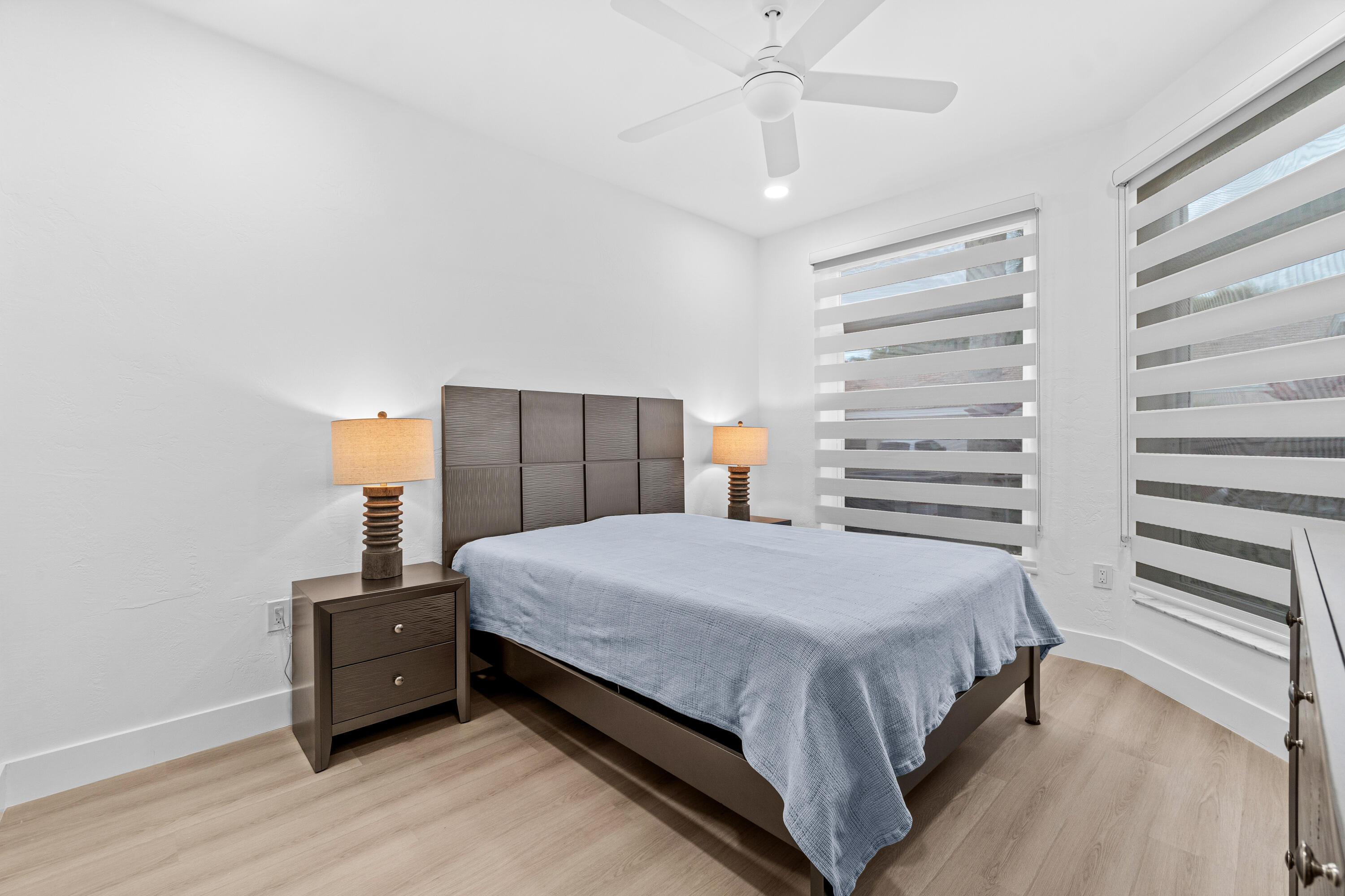 5097 Windsor Parke Drive Boca Raton, FL 33496 - Photo 21 of 27 a bedroom with a bed and wooden floor
