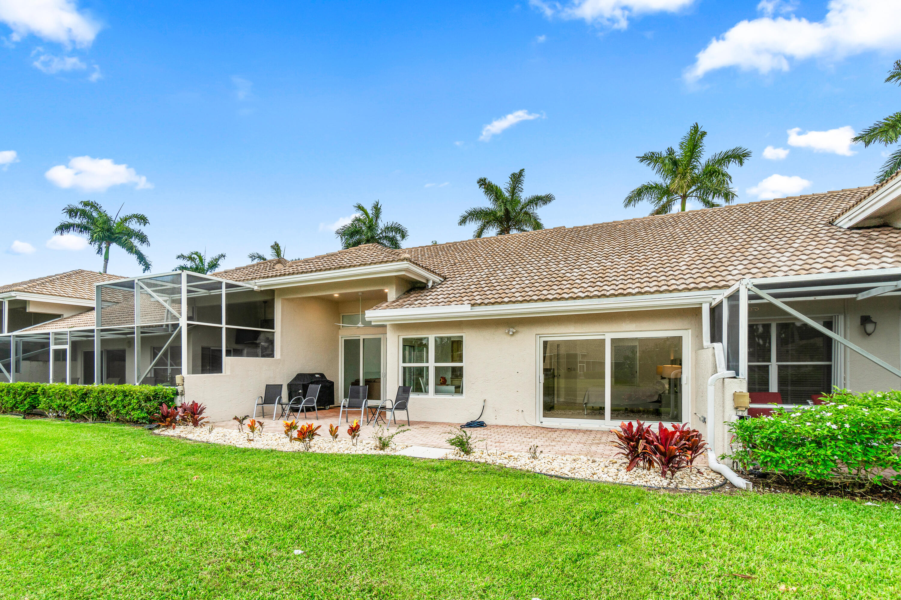 5097 Windsor Parke Drive Boca Raton, FL 33496 - Photo 26 of 27 a front view of house with a garden and patio