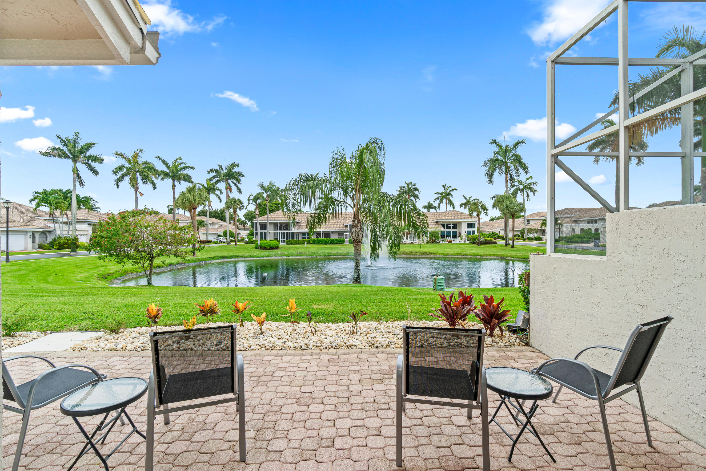 5097 Windsor Parke Drive Boca Raton, FL 33496 - Photo 8 of 27 a table and chairs in patio next to a yard