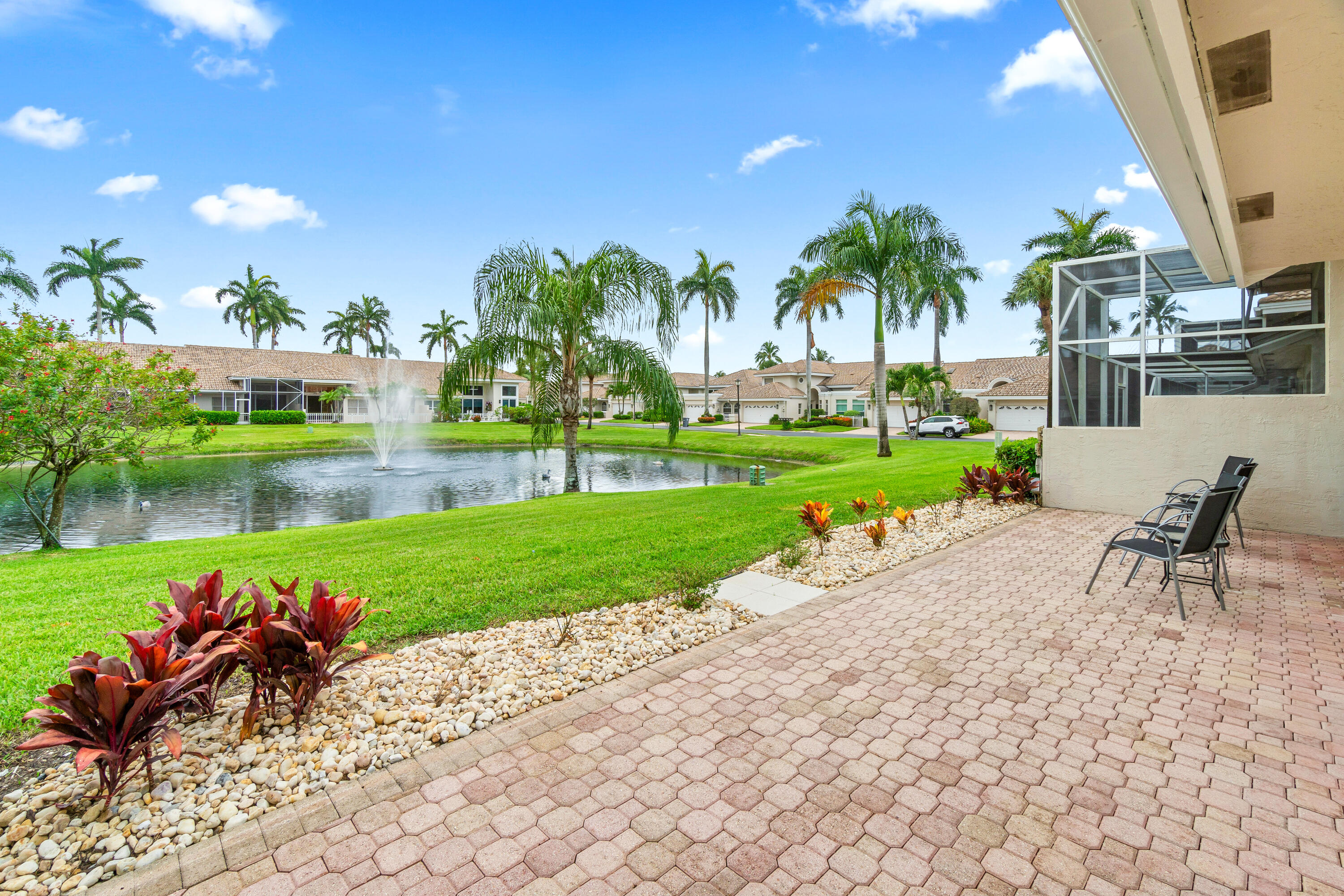 5097 Windsor Parke Drive Boca Raton, FL 33496 - Photo 10 of 27 a view of a chair and table on the garden
