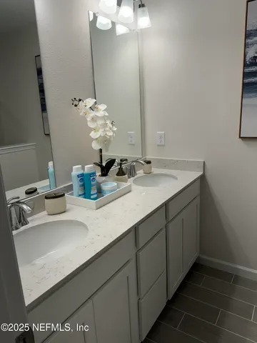 a bathroom with a sink and a mirror