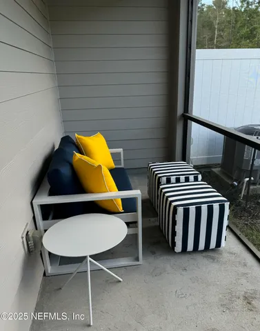 a balcony with a table and chairs