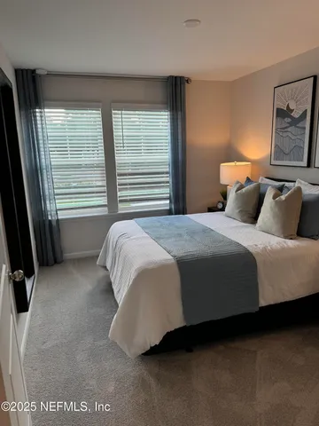 a bedroom with a bed and window