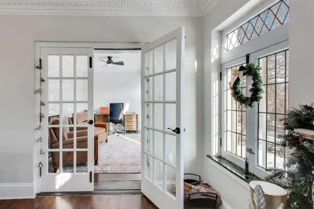 a work room with furniture wooden floor and a window