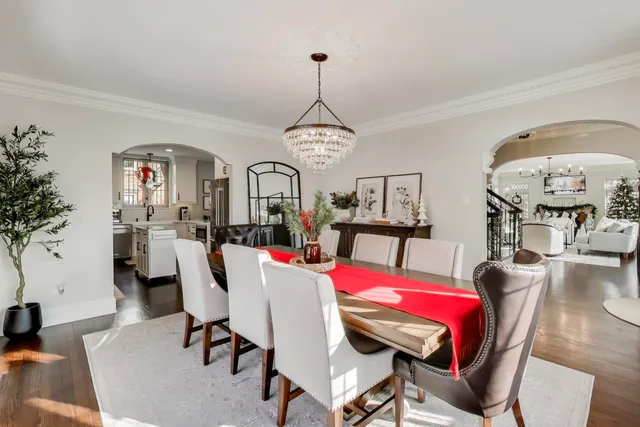 a kitchen with stainless steel appliances a stove a refrigerator and white cabinets