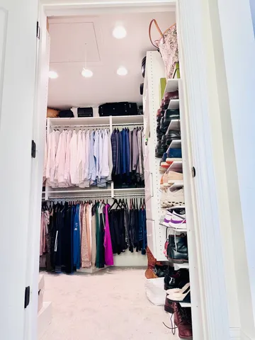 a bedroom with a bed and a book shelf