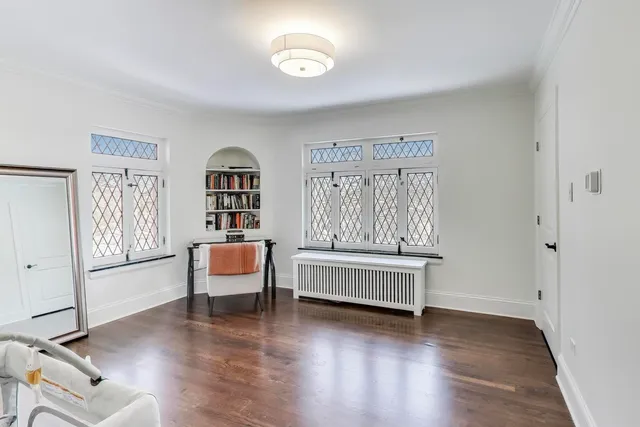 a bedroom with a bed and a white cabinet