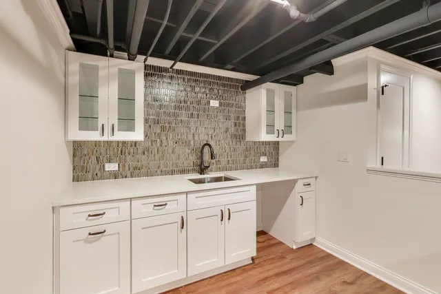 a front view of a house with large trees