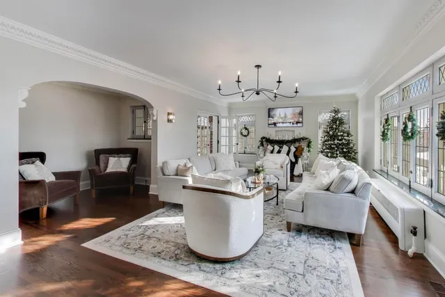 a living room with fireplace furniture and a chandelier