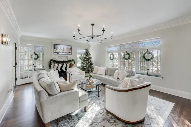 a living room with furniture and a chandelier