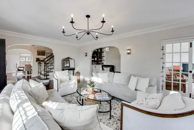 a living room with furniture a dining table and chairs