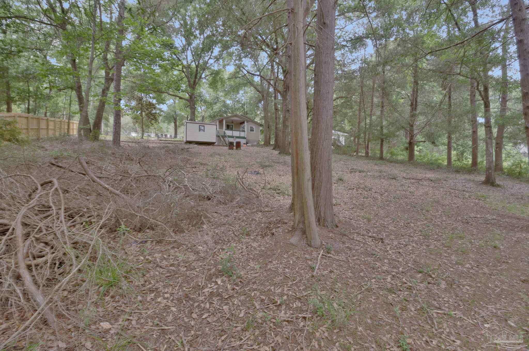 10290 West Lake Road Milton, FL 32583 - Photo 34 of 53 a view of a yard with tree s