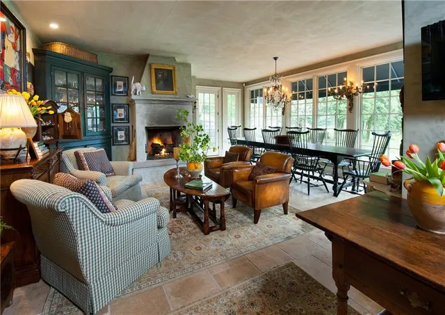 a living room with furniture fireplace and flat screen tv