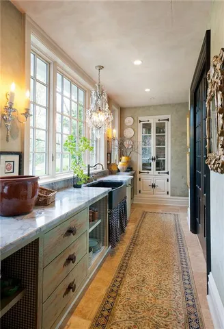 a kitchen with counter top space and windows