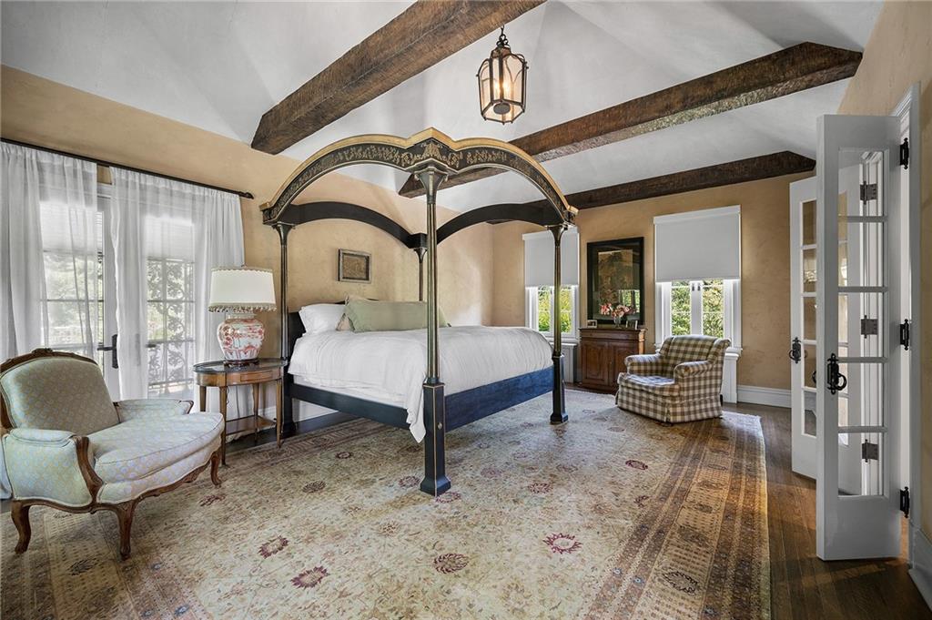 833 Blackburn Road Sewickley, PA 15143 - Photo 14 of 19 a spacious bedroom with a bed a couch and large window with garden view