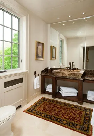 a bathroom with a sink a toilet and mirror