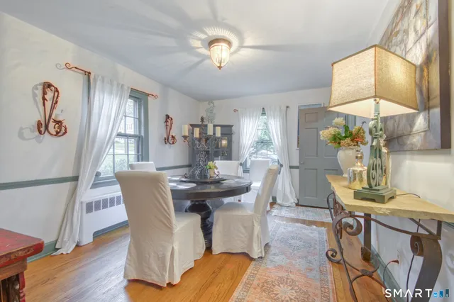 a view of a dining room with furniture and chandelier