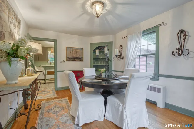 a view of a dining room with furniture and chandelier