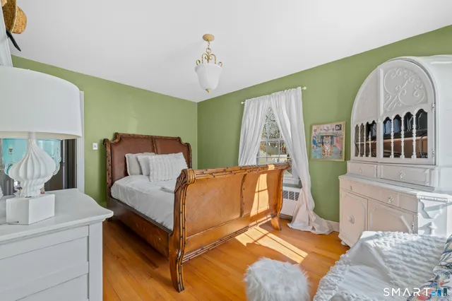 a living room with a bed furniture and a large window