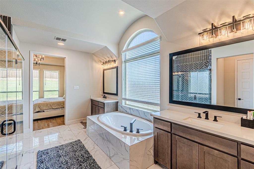 116 Derrett Lane Rhome, TX 76078 - Photo 12 of 30 a bathroom with a tub double vanity sink and mirror