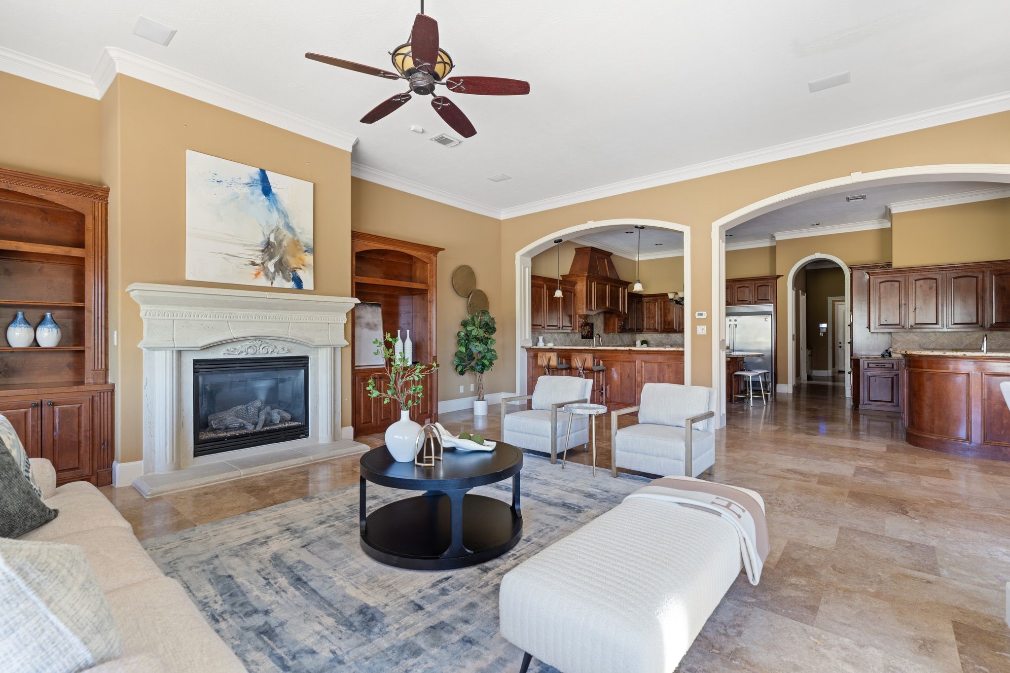 16502 Glorietta Turn Houston, TX 77068 - Photo 16 of 50 Family room with built ins on both sides of gas fireplace adjacent kitchen, wet bar & breakfast area