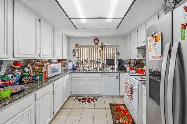 a utility room with fridge and window