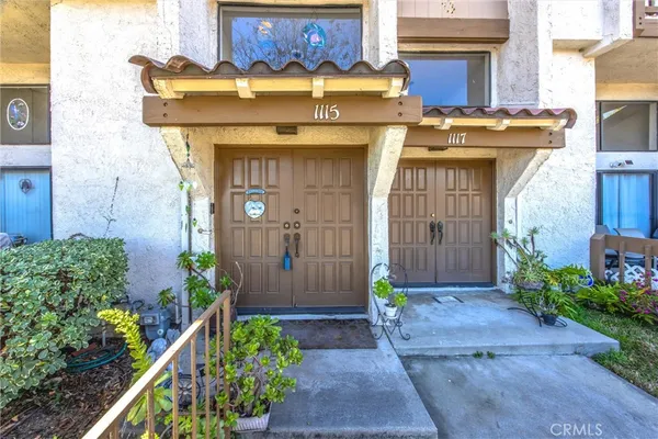 a front view of a house with plants