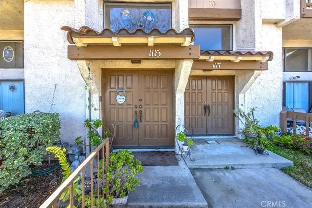 a front view of a house with plants