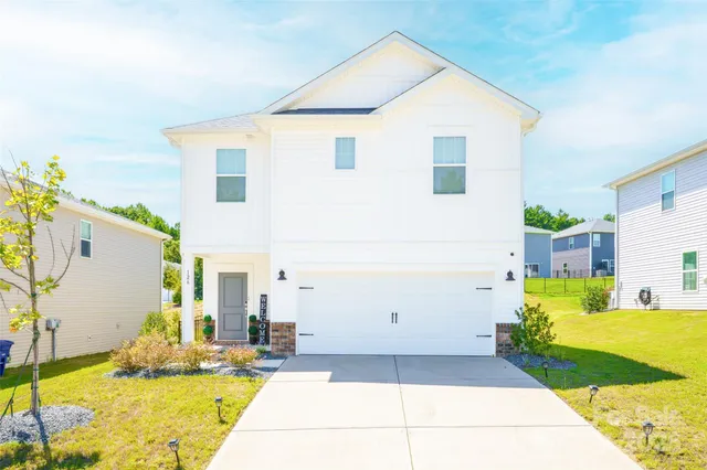 a view of a house with a backyard