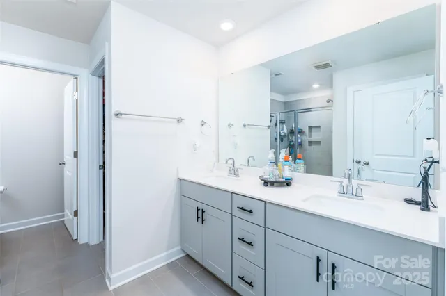 a bathroom with a double vanity sink mirror and double