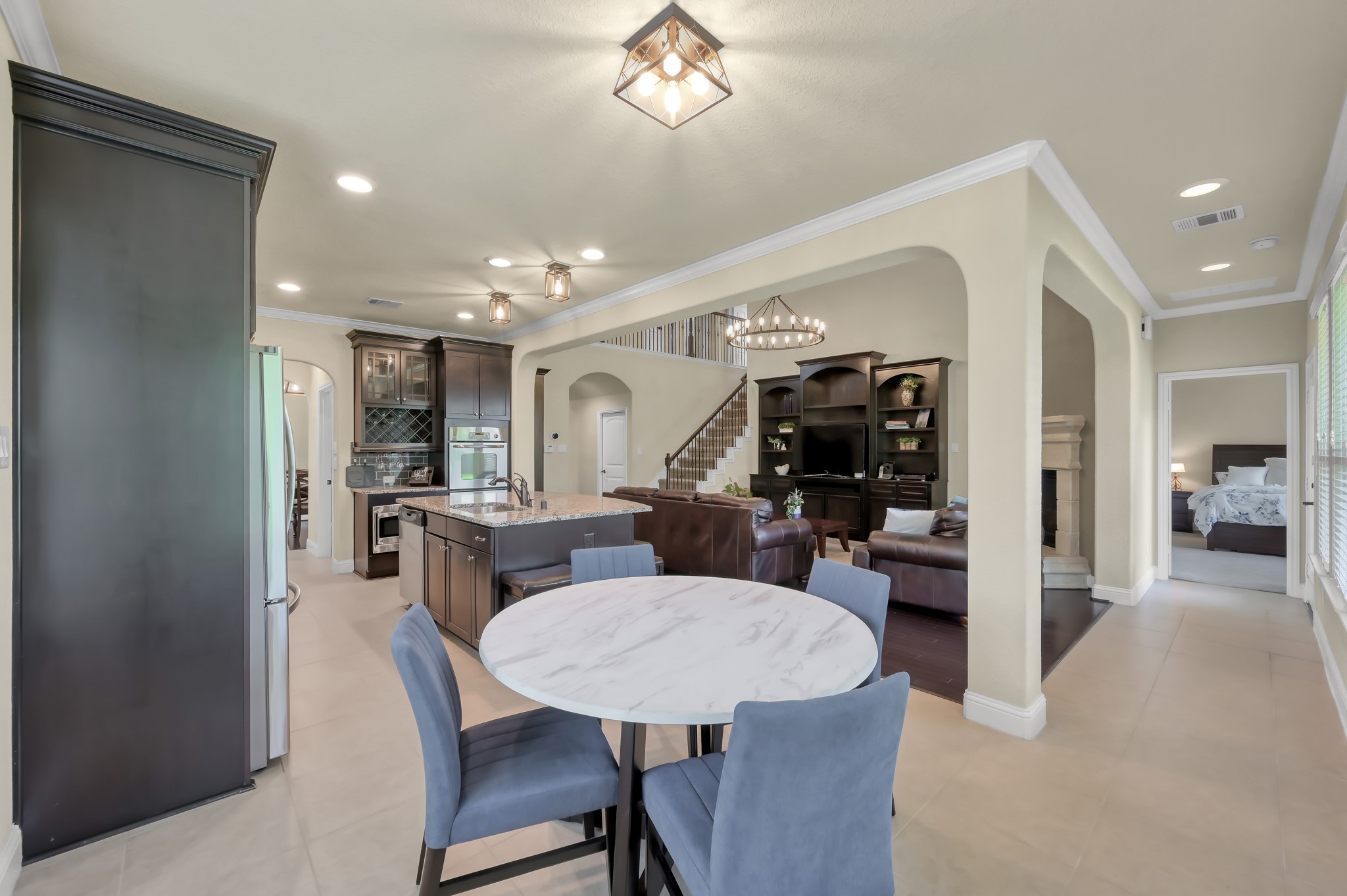 23 Rancher's Trail Tomball, TX 77375 - Photo 15 of 40 This inviting kitchen boasts a sleek, modern design with dark cabinetry, high-end stainless steel appliances, and a light-filled breakfast area perfect for morning gatherings.