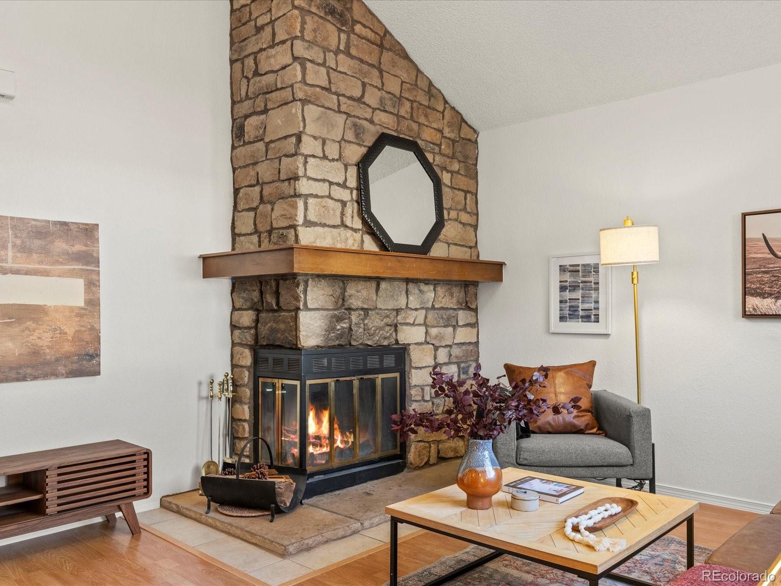 a living room with furniture a mirror and a fireplace