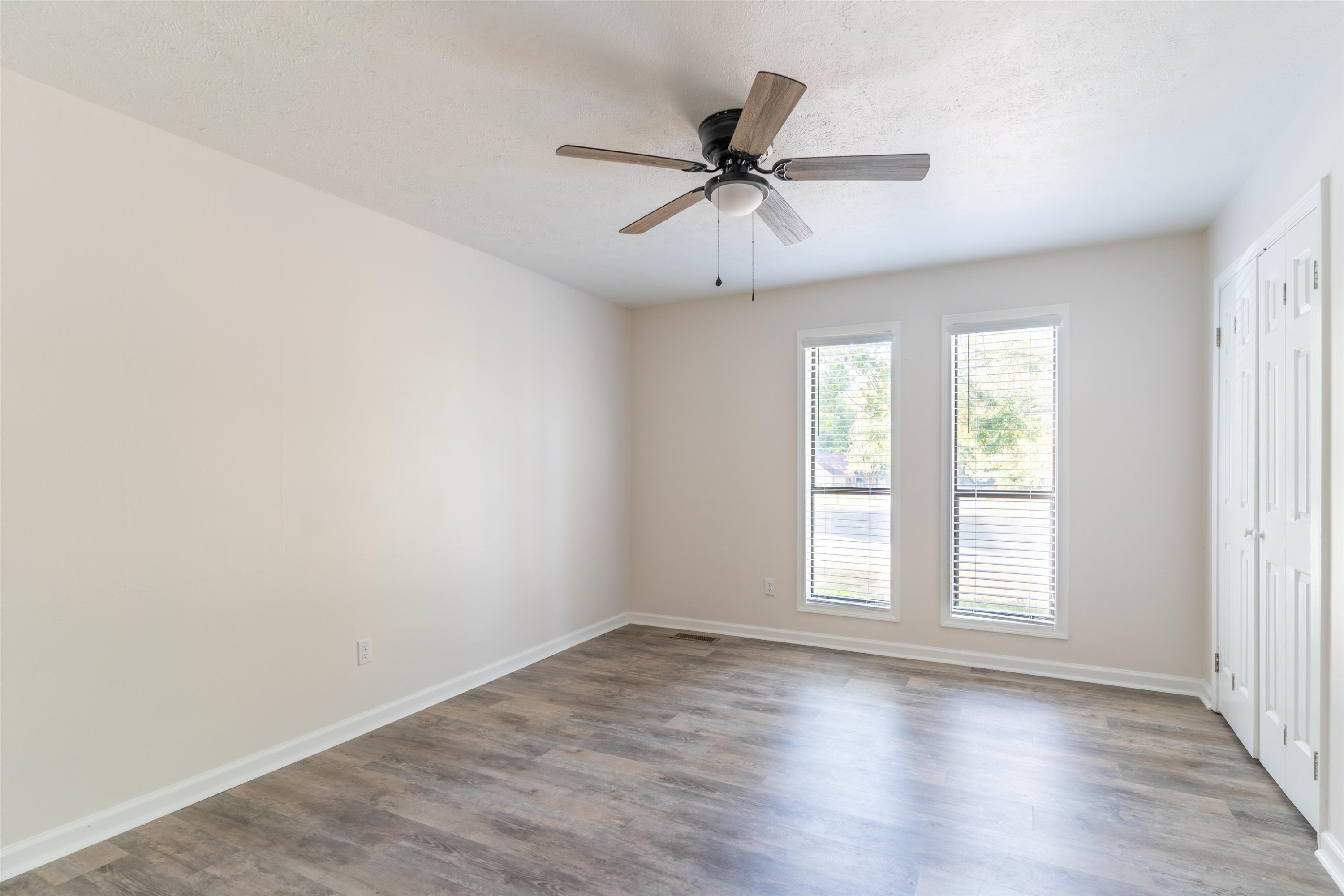 98 Ridgeoak Place Jackson, TN 38305 - Photo 17 of 23 an empty room with wooden floor fan and windows
